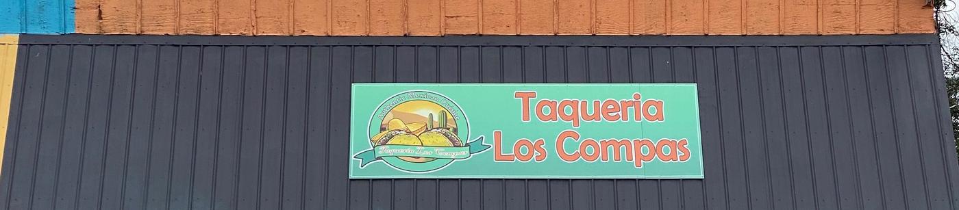 The Taqueria Los Compas sign on the front of our building on East Central Avenue